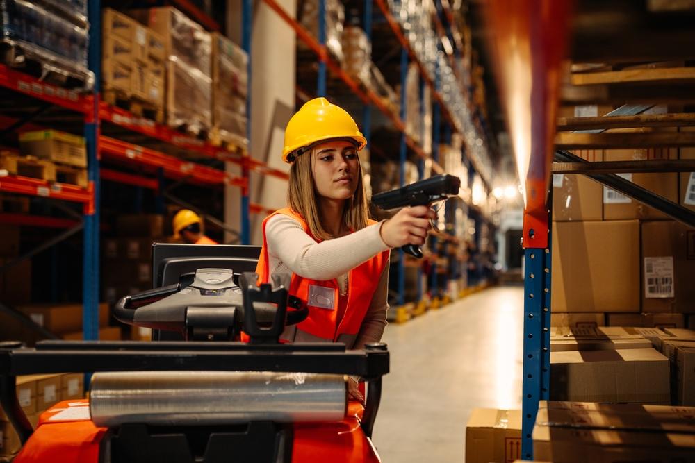Female,Warehouse,Worker,With,Safety,Helmet,Is,Working,With,Bar