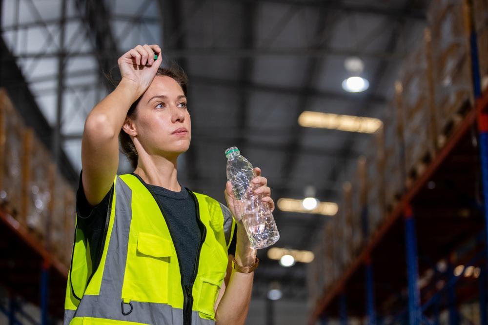 Women,Engineer,Drinking,Water,From,Plastic,Bottle,After,Working,At