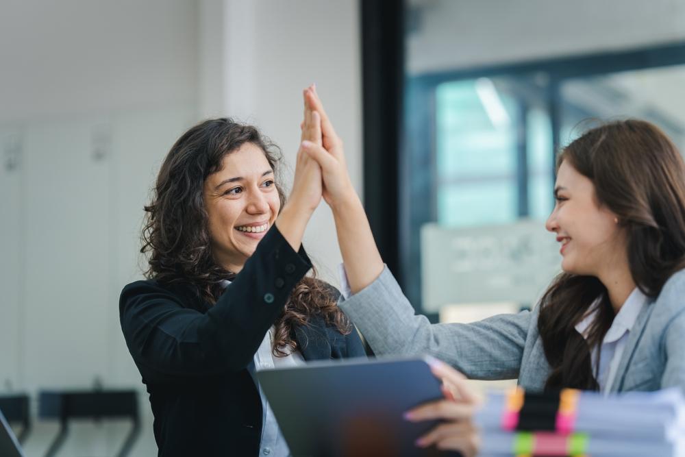 Young,Women,Working,Together,Hands,Together,Teamwork,Smiling,Happy,And