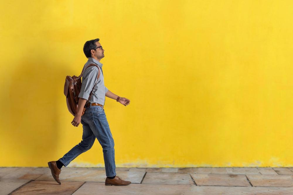 An,Employee,With,A,Bag,On,His,Back,Walking,To